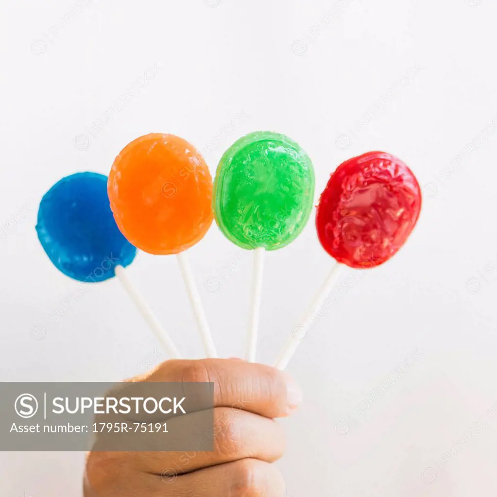 Hand holding colorful lollypops