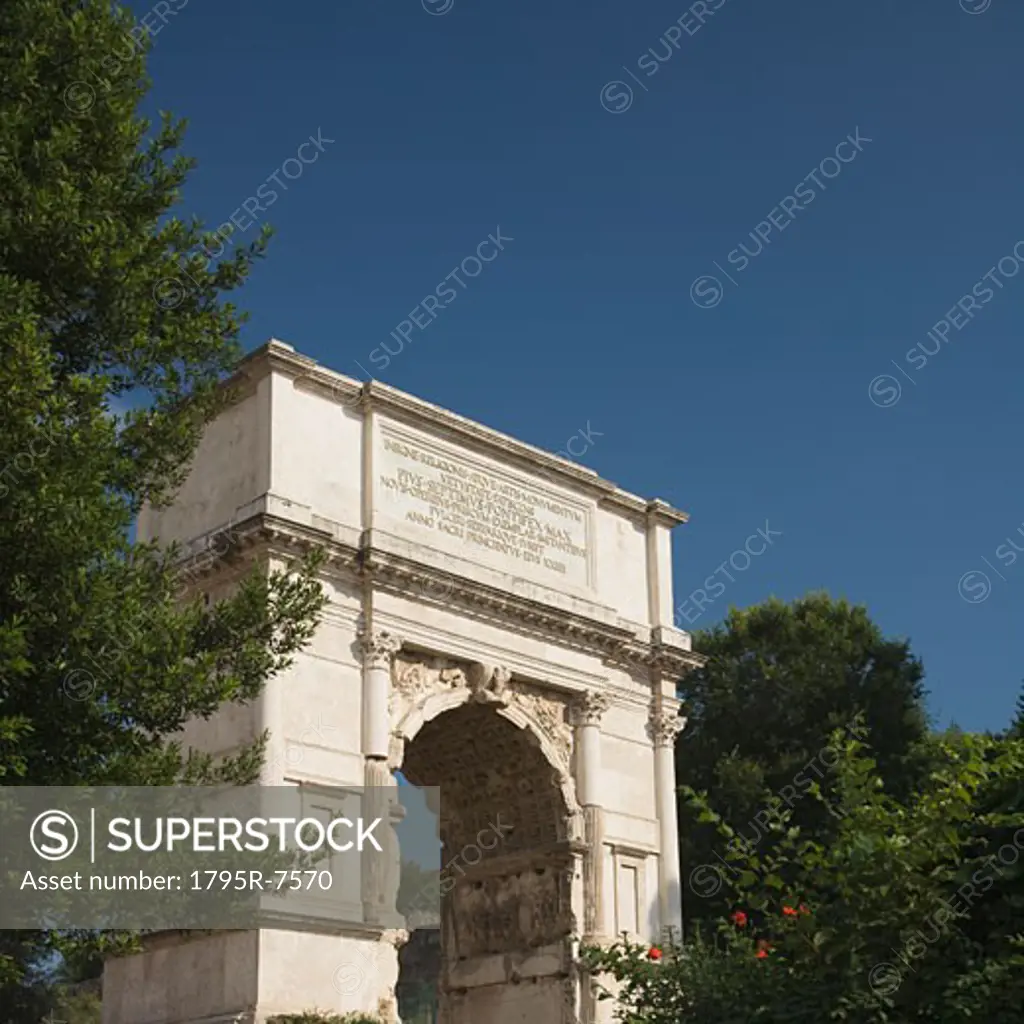 The Arch of Titus under blue sky, Roman Forum, Italy