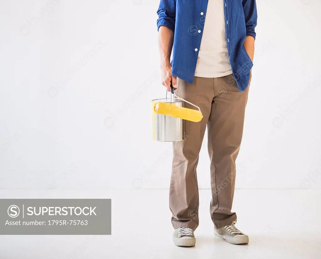 Man holding painting roll