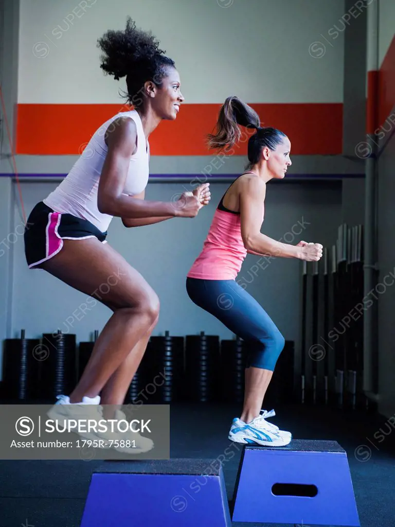 Two women in step aerobics class