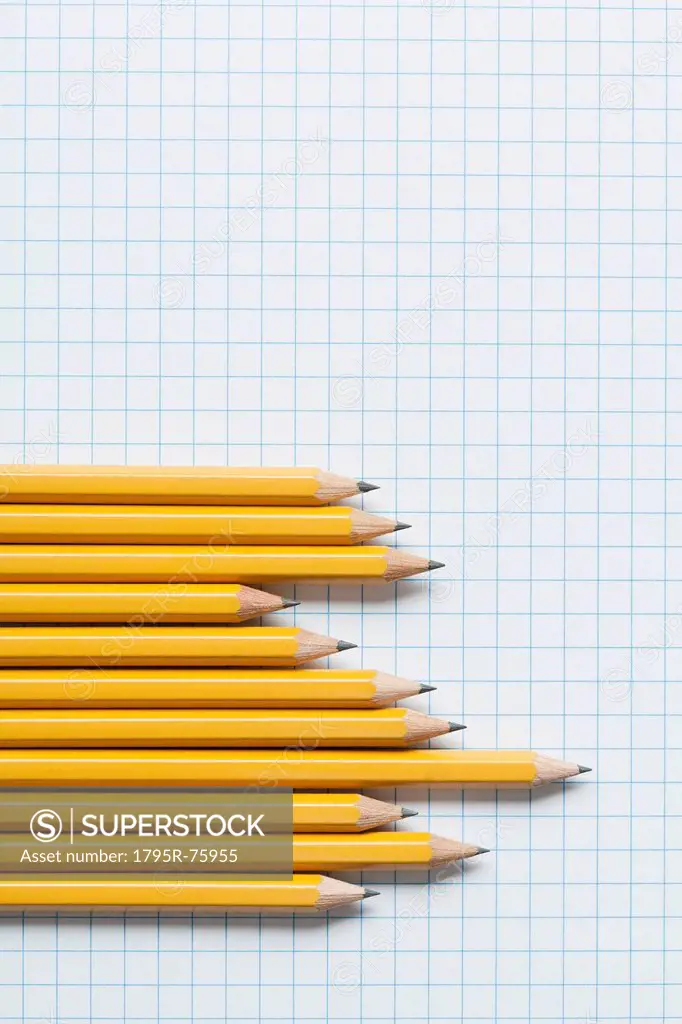 Grouping of yellow pencils in graph shape on graph paper