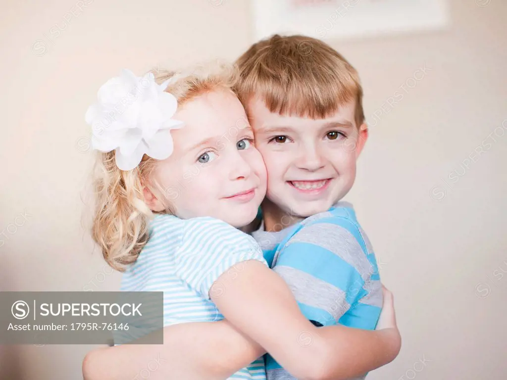 Studio Shot, Portrait of sister and brother hugging each other