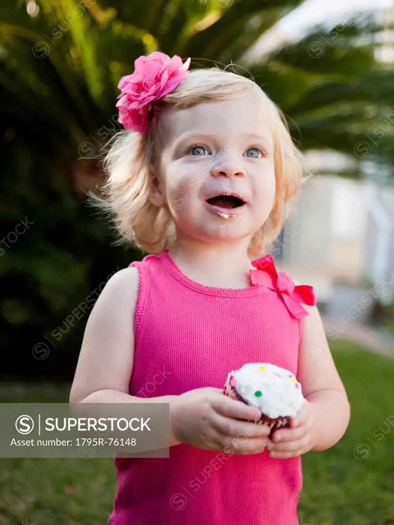 Girl holding cupcake