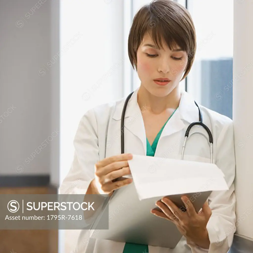 Female doctor reading chart