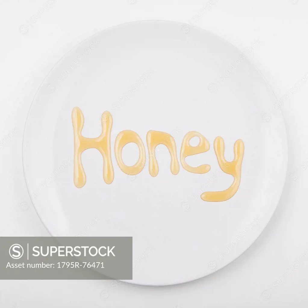 Word HONEY on white plate