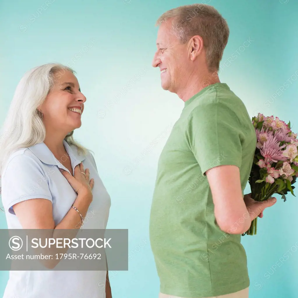 Man giving bouquet to woman
