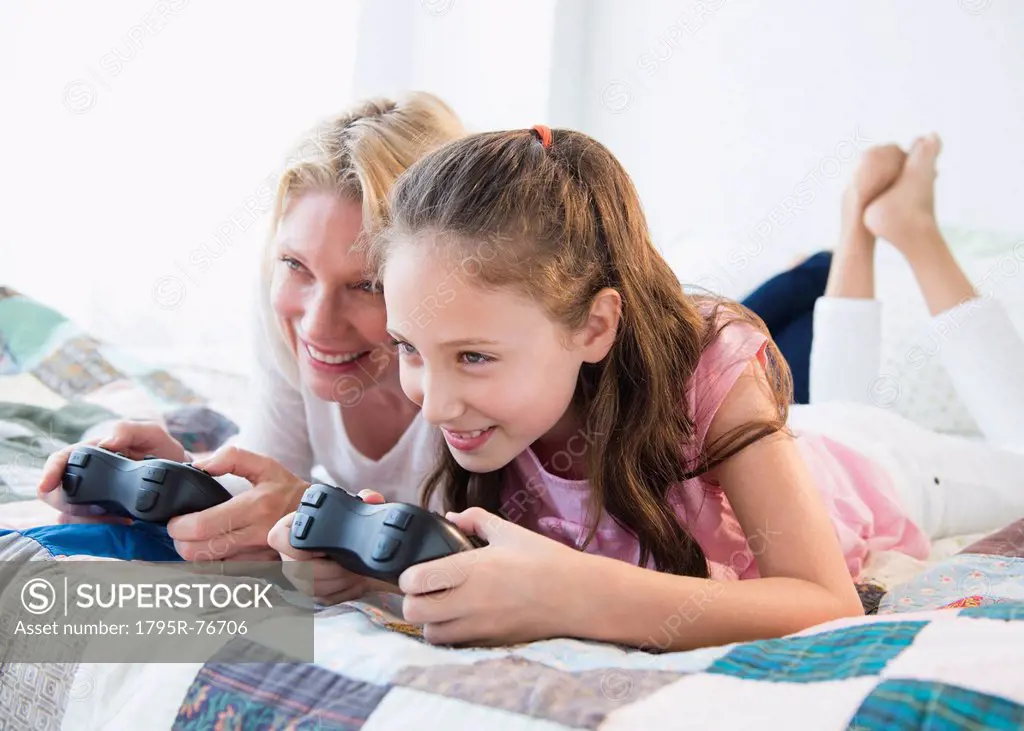 Mother and daughter 8_9 years playing video games