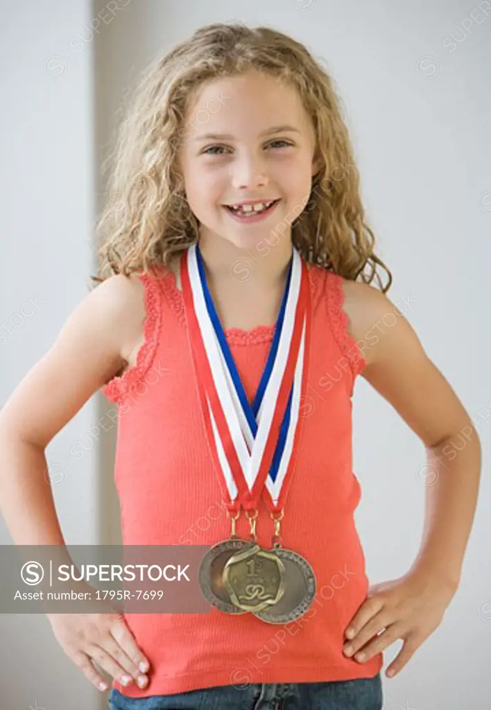 Girl wearing medals around neck