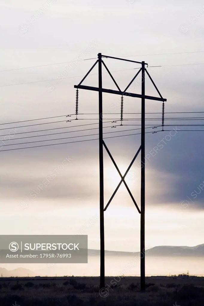 Power lines and tower at sunset