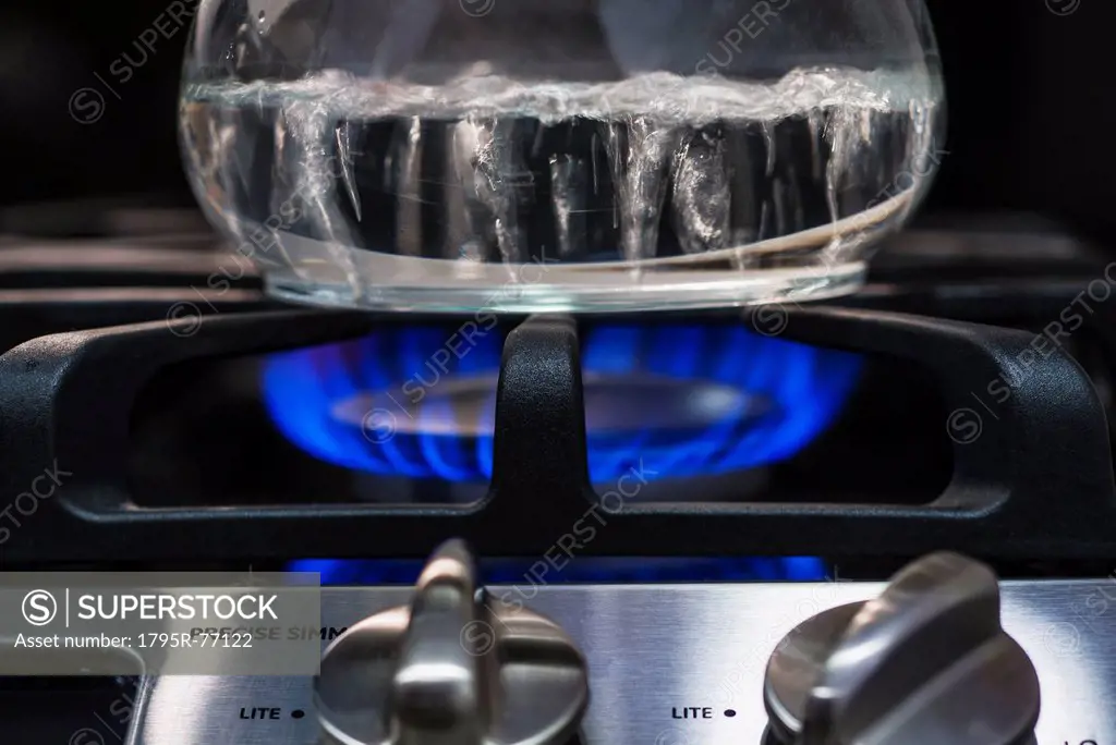 Close_up of water boiling on gas burner