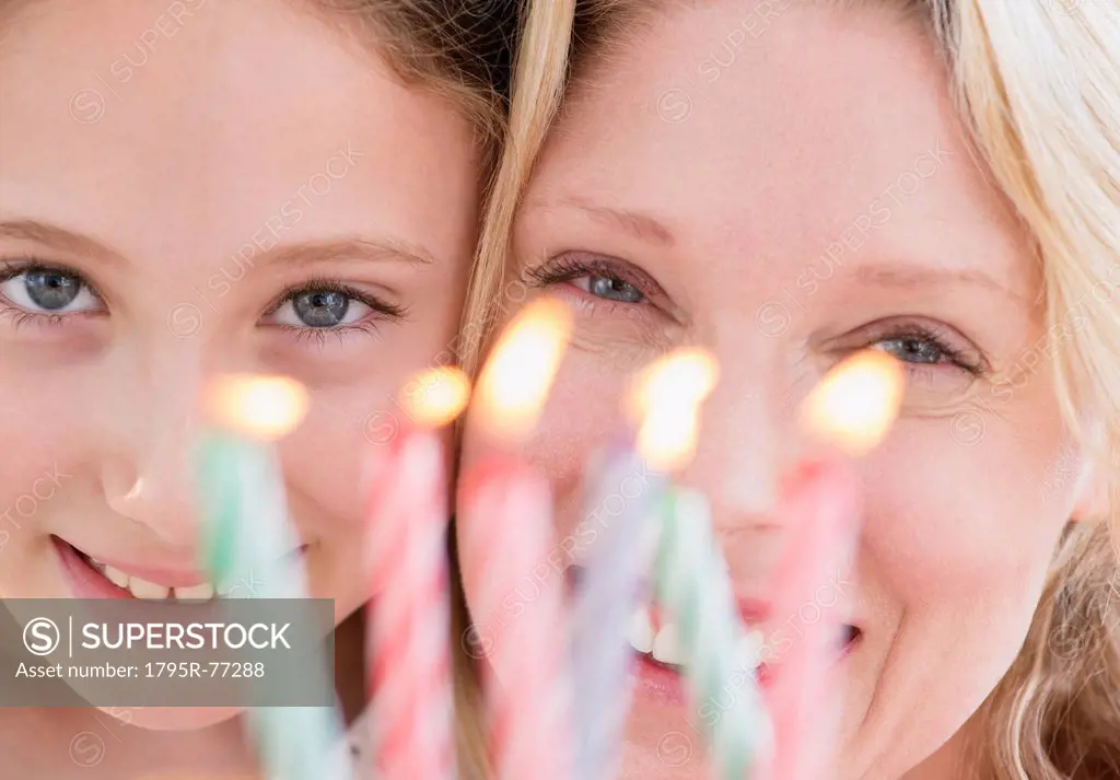 Portrait of mother and daughter 8_9 years with birthday candles