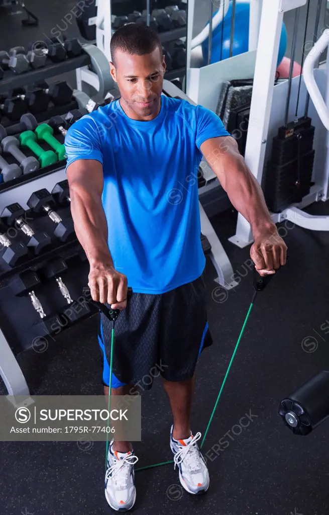 Young athlete man exercising in gym