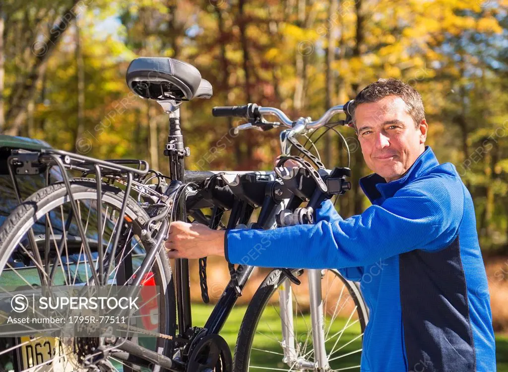 Man putting bicycle onto bike rack