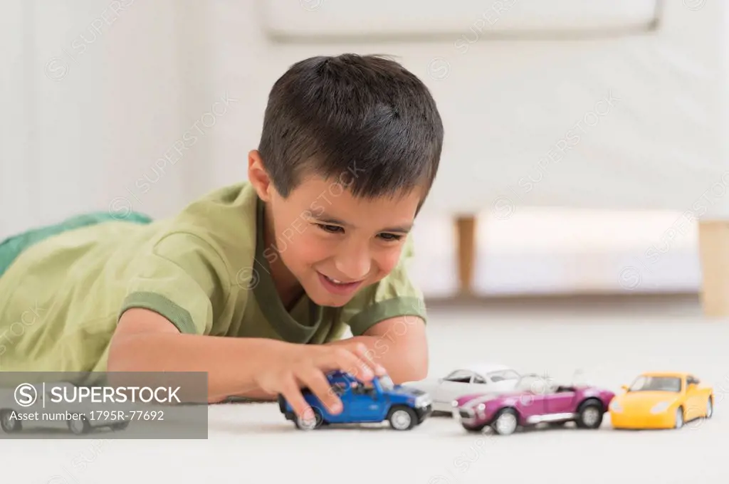Portrait of boy 6_7 playing with toy cars
