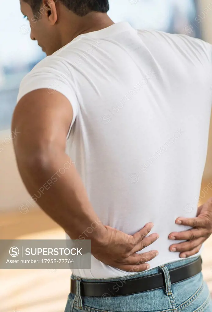 Man massaging his back