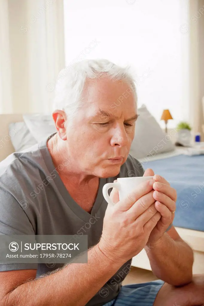 Senior man holding mug