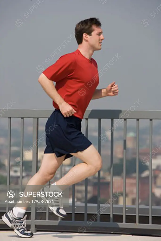 Man jogging on urban sidewalk