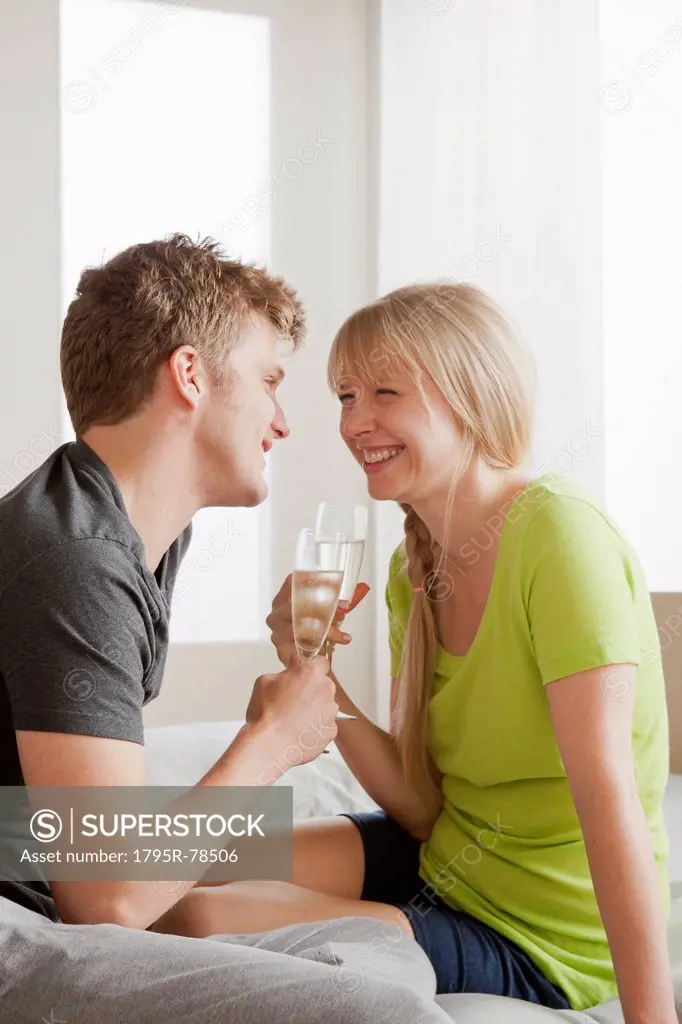 Couple enjoying champagne in bed