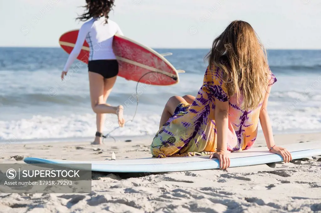 Two female surfers on beach