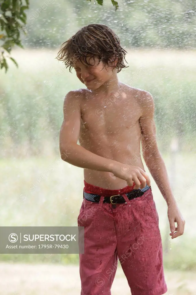 Boy 10_11 playing with splashing water