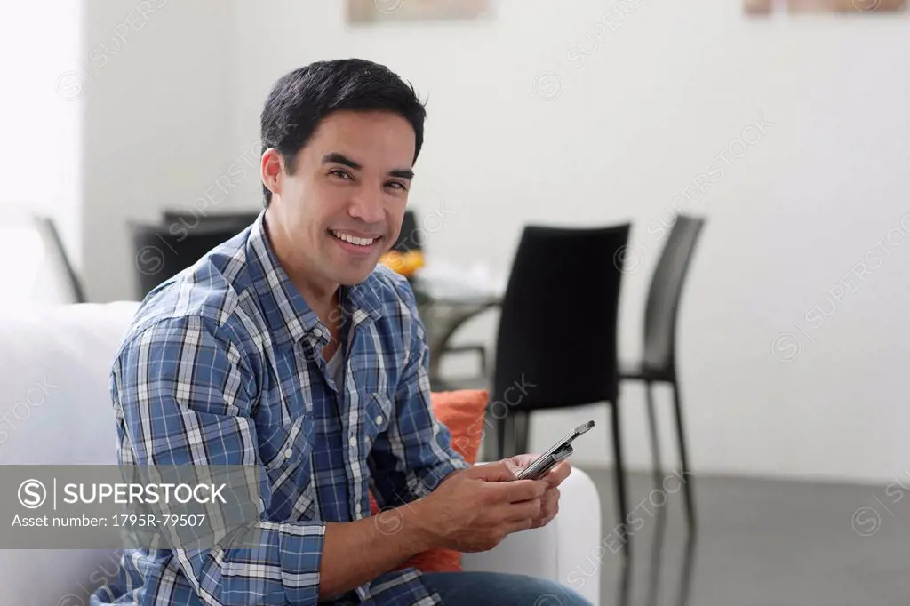 Man texting in living room