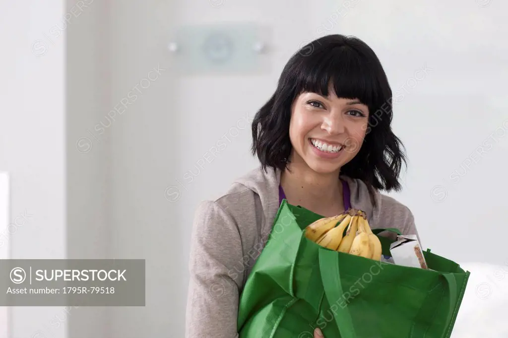 Portrait of young woman with shopping bag