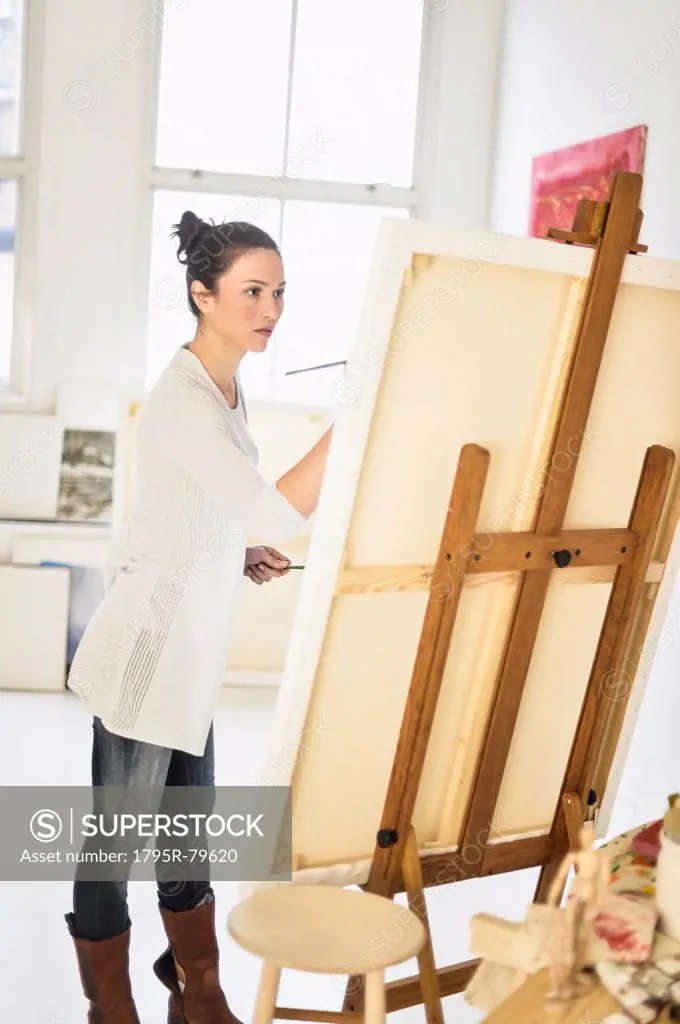 Woman painting at easel