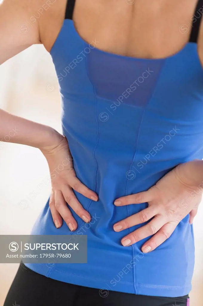 Midsection of woman with hands on back