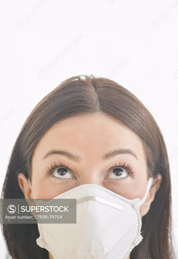 Studio portrait of woman wearing flu mask