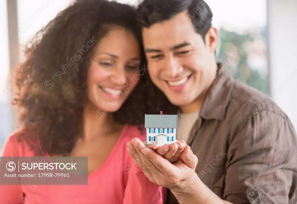 Smiling couple with model home