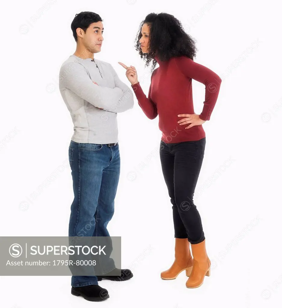 Studio shot of young couple arguing