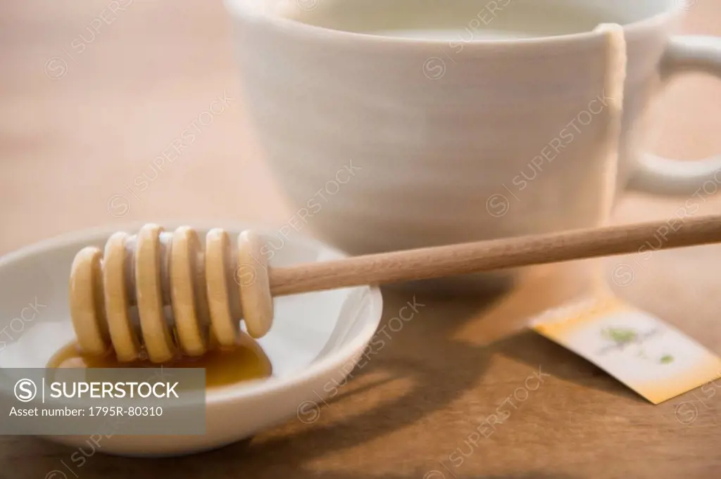 Studio shot of tea cup and honey spoon