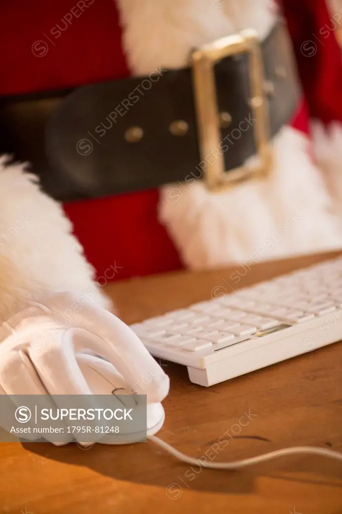 Close-up of santa claus using computer