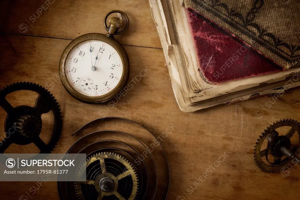 Still life with pocket watch and gears