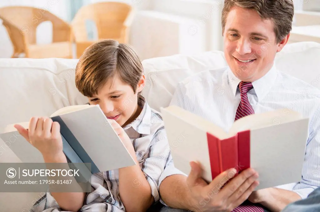 Father and son (8-9) reading books