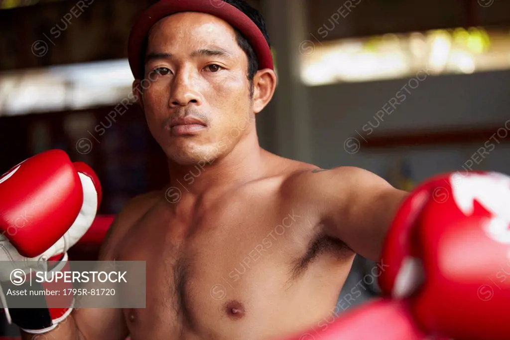 Portrait of mid adult male boxer in fighting stance