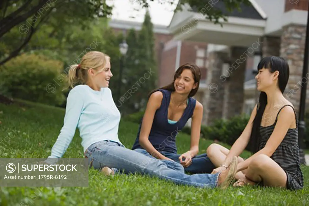 Young women talking in grass