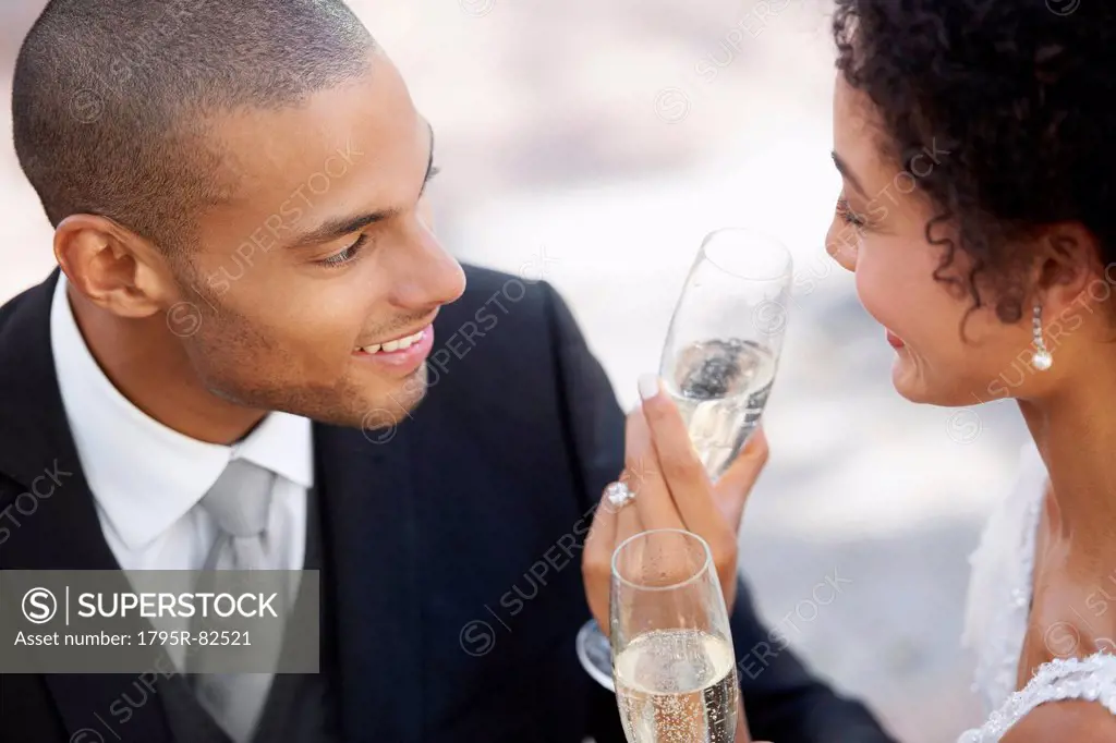 Newly wed couple drinking champagne