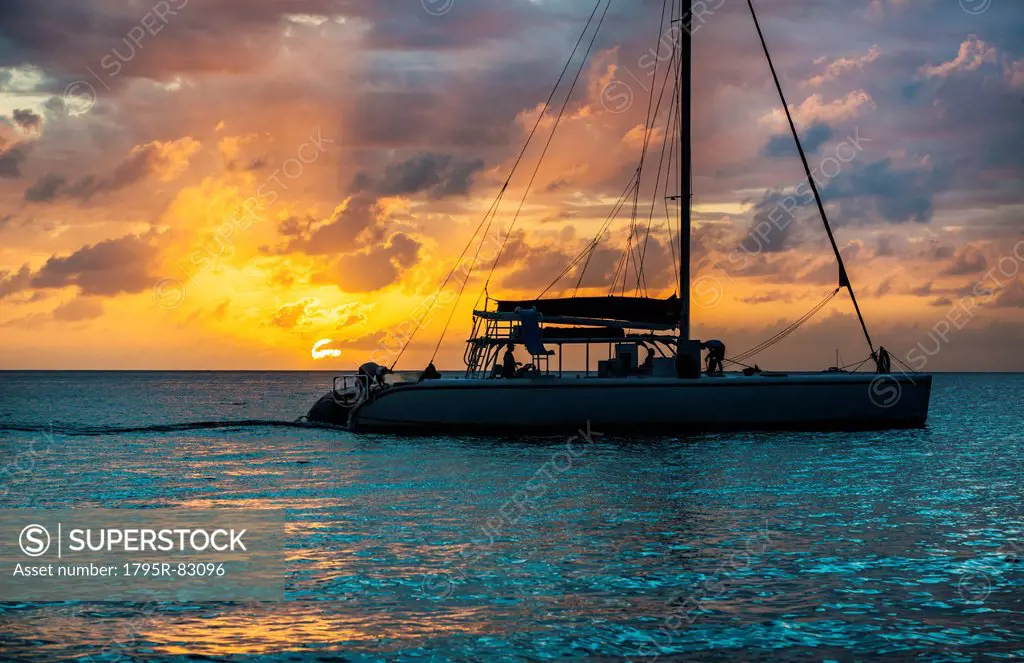 Catamaran on sea at sunset
