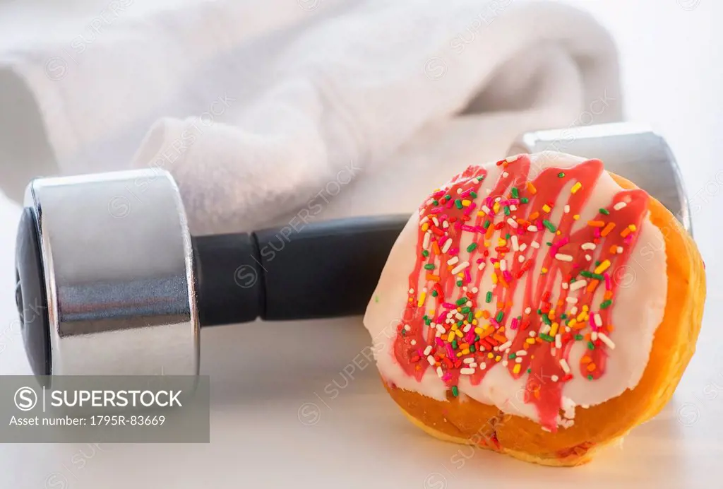 Studio Shot of jelly doughnut and hand weight