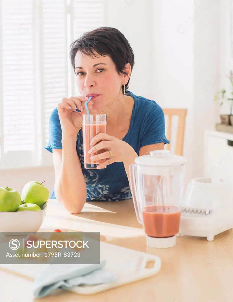 Portrait of mature woman drinking smoothie