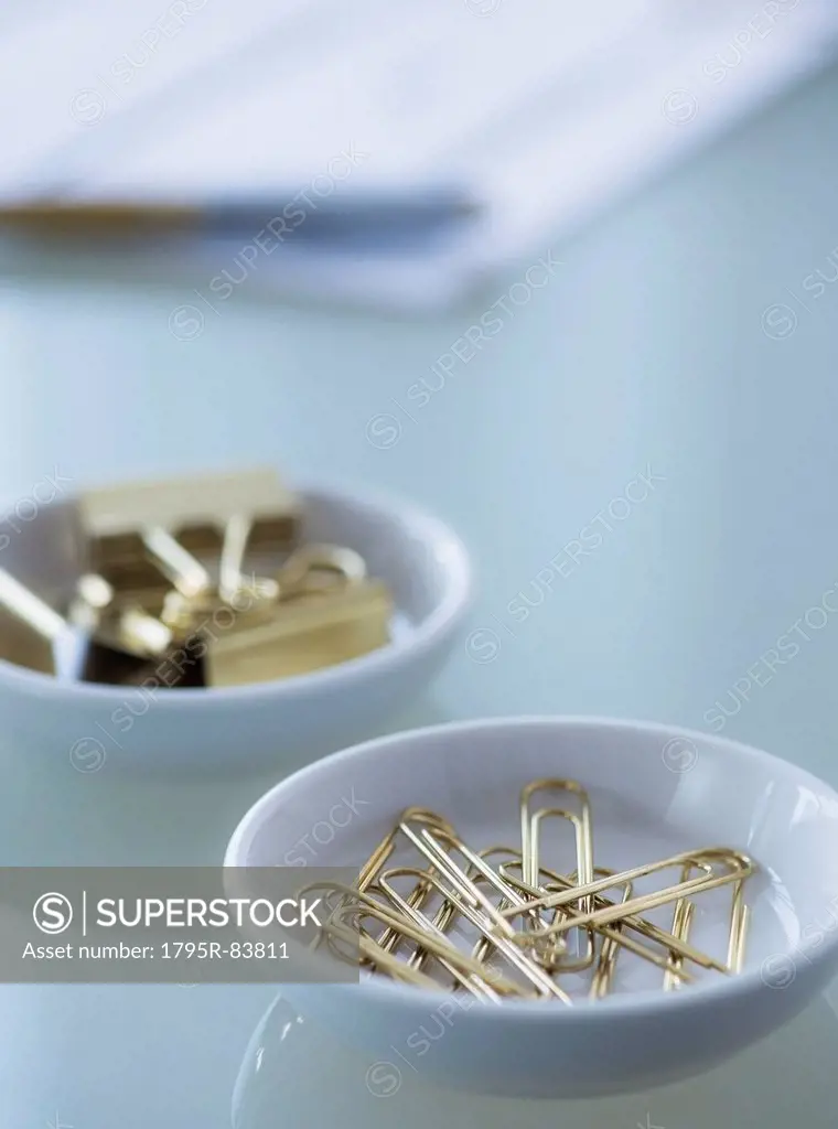 Close-up of paper clip and binder clip