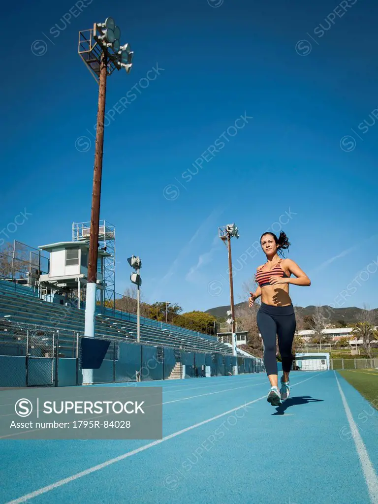 Woman running at sports field