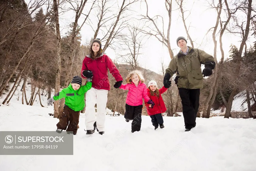 Three children (2-3, 4-5) with parents during stroll