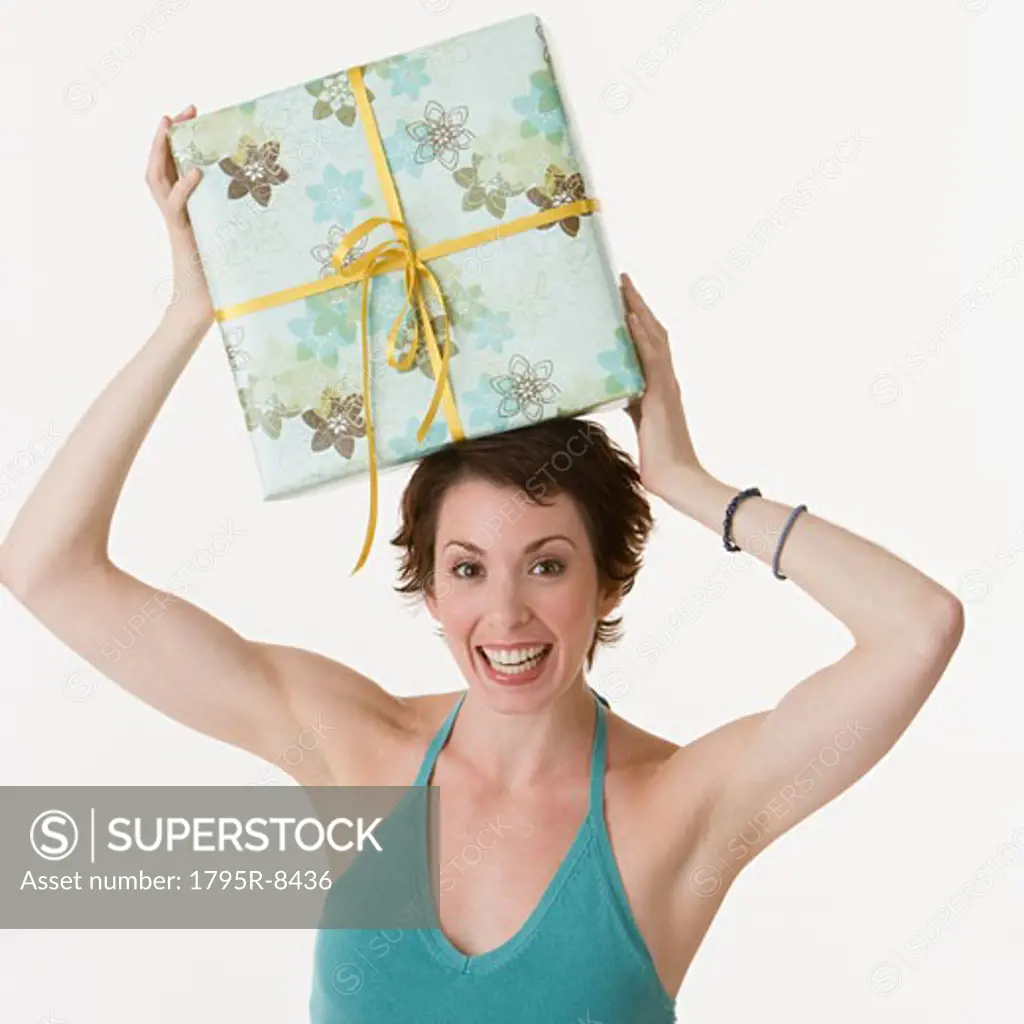 Woman holding gift on head