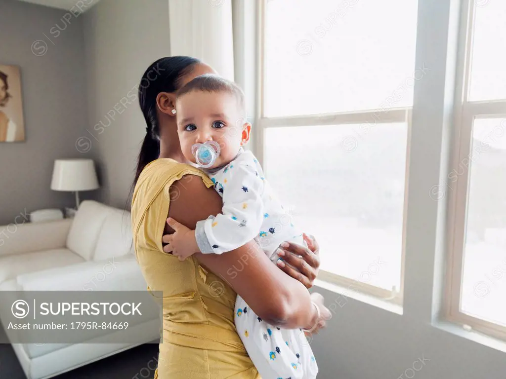 Woman holding her son (2-5 months)