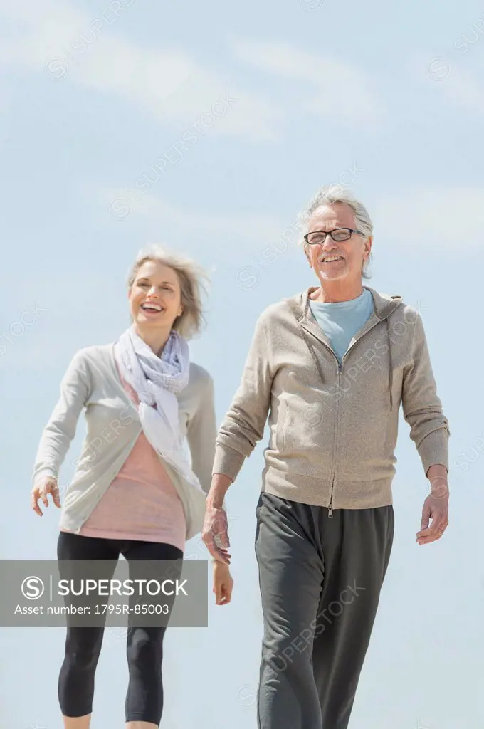 Senior couple walking and holding hands