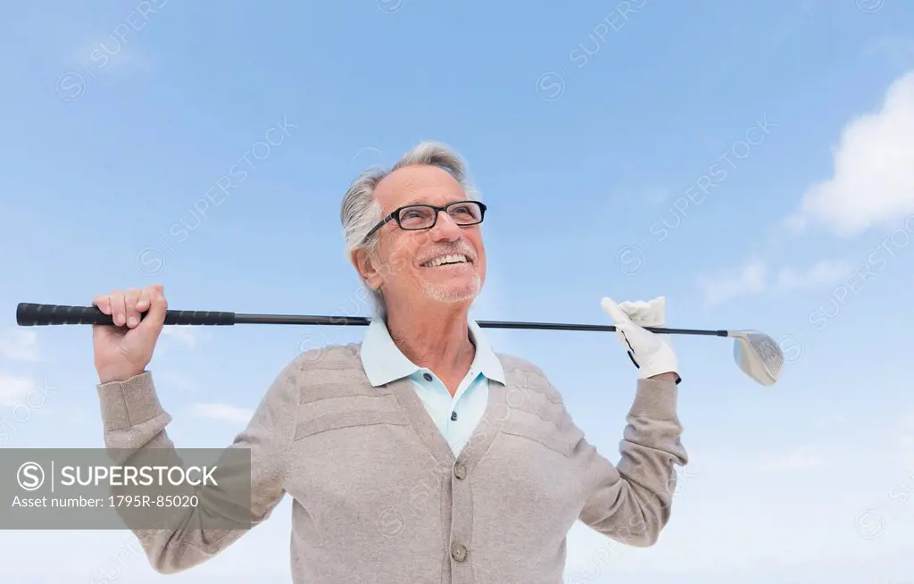 Senior man holding golf club