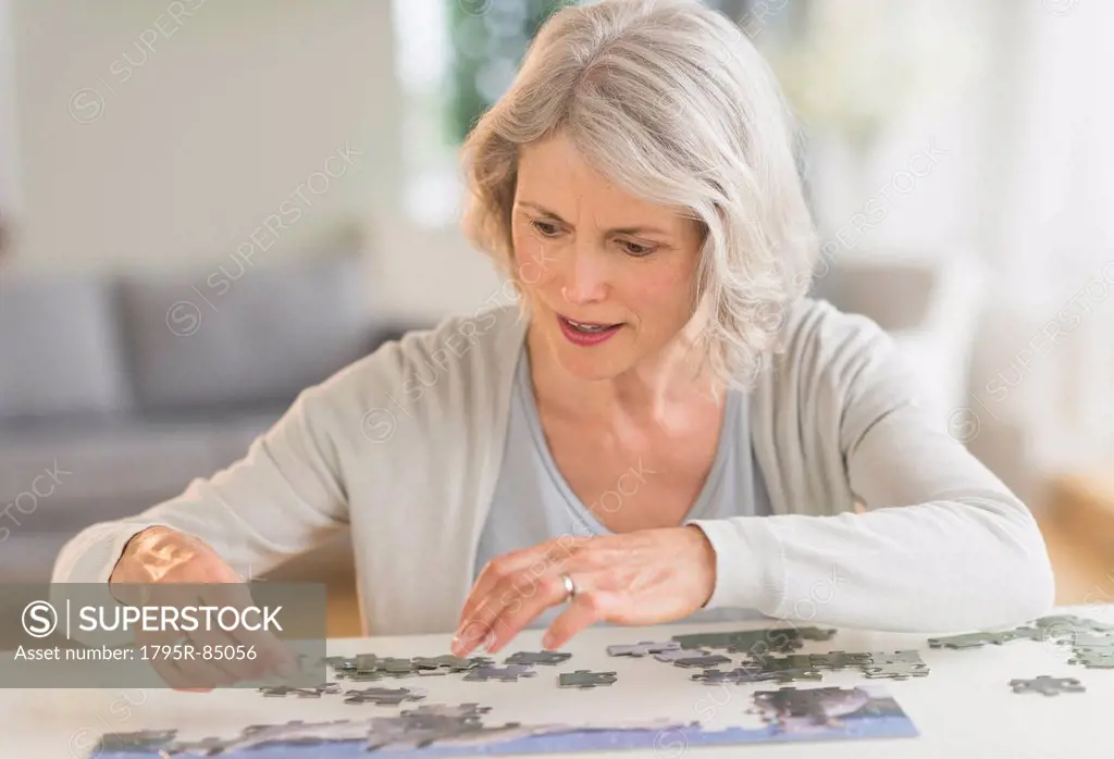 Senior woman completing jigsaw puzzle