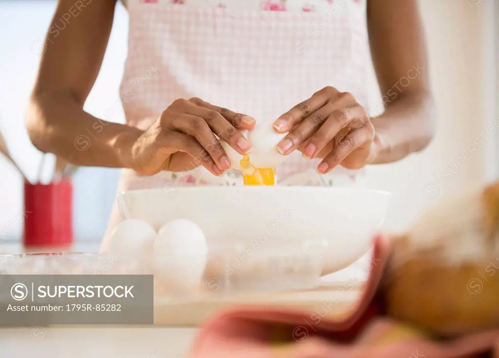 Mid section of woman separating eggs